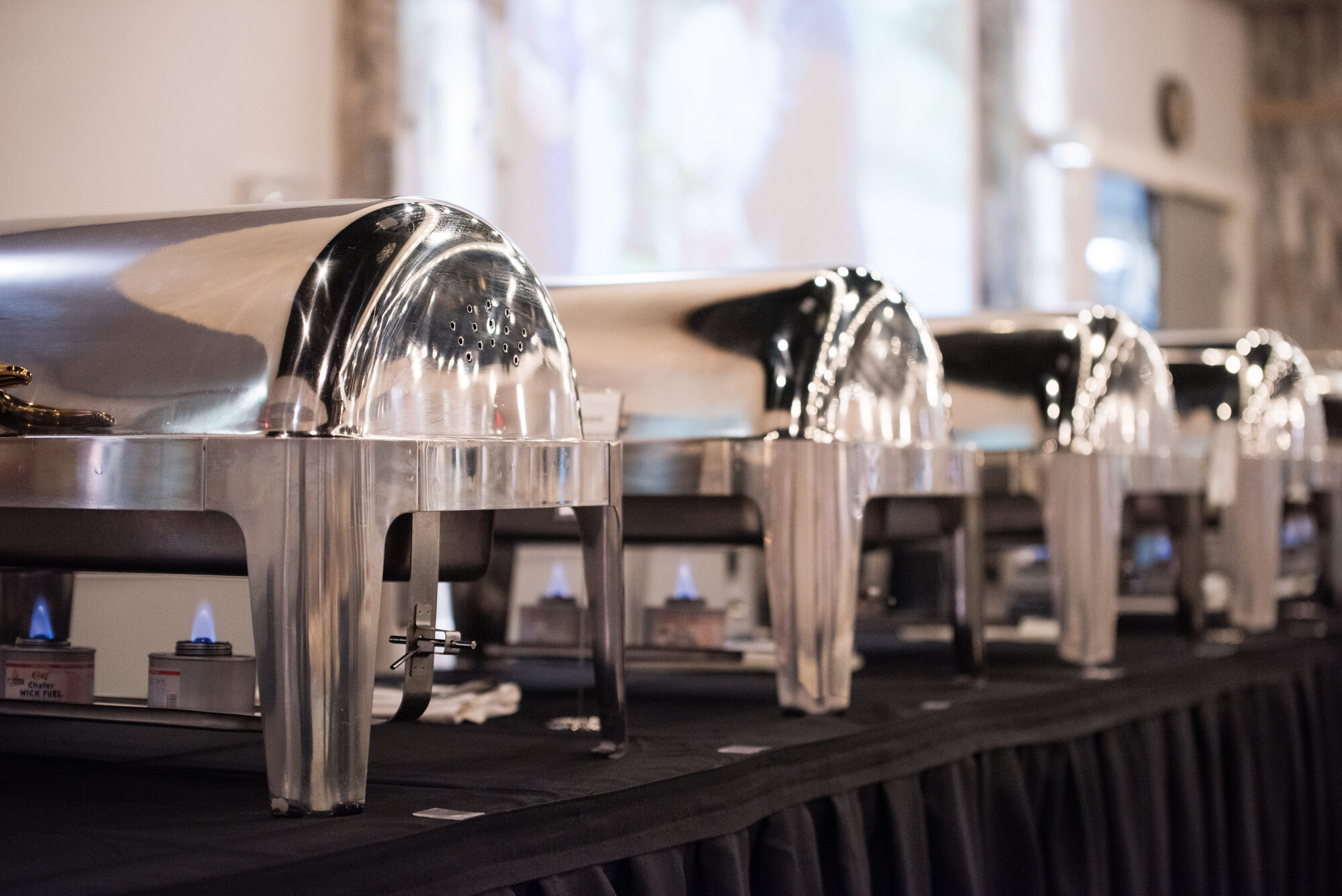 Polished chafing dishes lined up for buffet service