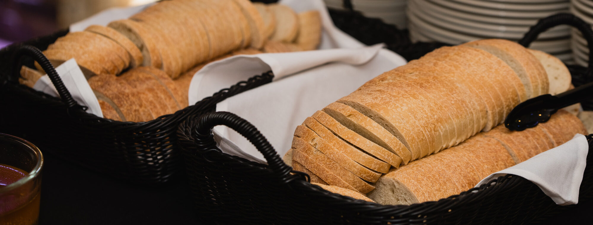 Baskets of sliced Italian bread at a Brianno's Catering buffet