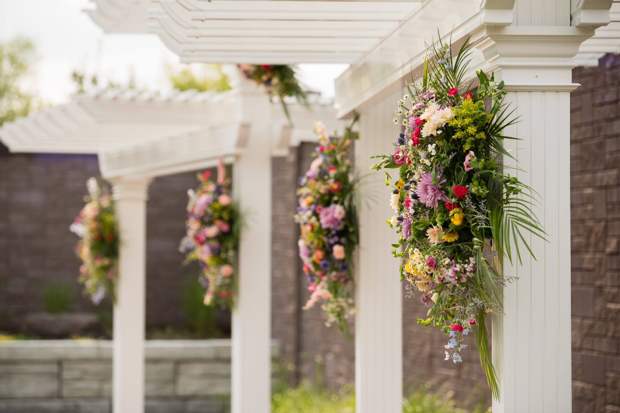 Wildflower florals decorating a pergola at a Fab! Weddings venue