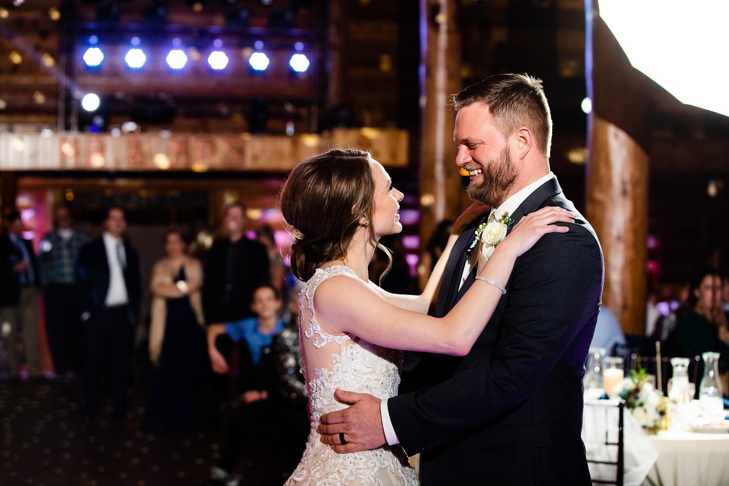 Bride and groom laughing together during their first dance as guests watch at Glenhaven Events, Farmington MN