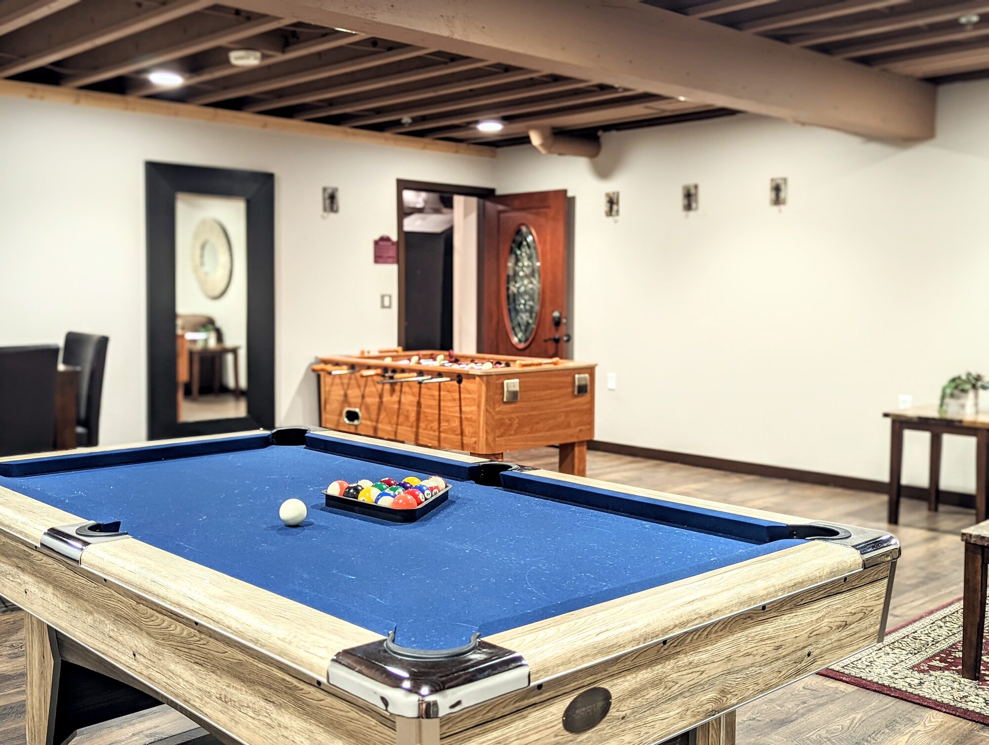 Glenhaven groom's room game lounge with a pool table, foosball table, and arcade under timber-beamed ceilings, Farmington MN