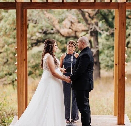 Rev. Vicky Carlson with a couple at their wedding ceremony